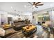 Open-concept living room with hardwood floors, cozy seating and sliding glass door to patio at 417 Honeybrush Ave, Henderson, NV 89011
