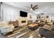 Spacious living room with a stone fireplace, wood-look floors, and comfortable seating arrangements at 417 Honeybrush Ave, Henderson, NV 89011