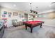 Spacious living room area with a pool table and adjacent wet bar at 417 Honeybrush Ave, Henderson, NV 89011
