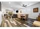 Open concept living space with dining area and multiple seating options, all with wood-look floors at 417 Honeybrush Ave, Henderson, NV 89011