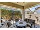 Patio features outdoor seating around a fire pit, a water feature, and lattice at 417 Honeybrush Ave, Henderson, NV 89011
