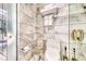 Modern bathroom with marble tiles, a toilet, and a sleek glass-enclosed shower offers a luxurious and clean design at 4381 W Flamingo Rd # 901, Las Vegas, NV 89103