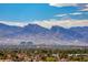 Picturesque city view showcasing modern high-rise buildings amidst lush green trees with breathtaking mountain backdrop at 4381 W Flamingo Rd # 901, Las Vegas, NV 89103