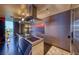 Modern stainless steel kitchen with a sleek range hood and black floors, a chef's dream at 4381 W Flamingo Rd # 901, Las Vegas, NV 89103