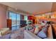 Stylish living room with comfortable seating, a modern fireplace, and city views at 4381 W Flamingo Rd # 901, Las Vegas, NV 89103