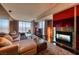 Elegant living room featuring a modern fireplace, a large TV, and a plush sofa at 4381 W Flamingo Rd # 901, Las Vegas, NV 89103