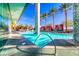 Resort-style pool area with palm trees and comfortable lounge chairs at 4381 W Flamingo Rd # 901, Las Vegas, NV 89103