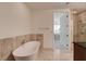 Upscale bathroom featuring a soaking tub and shower combo with modern fixtures and sleek design at 4525 Dean Martin Dr # 901, Las Vegas, NV 89103