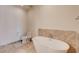 Luxurious bathroom featuring a modern soaking tub, toilet, and elegant tile work at 4525 Dean Martin Dr # 901, Las Vegas, NV 89103