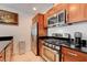 Modern kitchen features stainless steel appliances, granite countertops, and brown cabinets at 4525 Dean Martin Dr # 901, Las Vegas, NV 89103