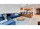 Bright living room features a blue velvet sofa, round coffee table and a kitchen bar with seating at 4525 Dean Martin Dr # 901, Las Vegas, NV 89103