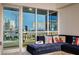 Relax in this stylish living area with modern sofa and a stunning cityscape backdrop visible through large windows at 4525 Dean Martin Dr # 901, Las Vegas, NV 89103