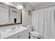 Neat bathroom with a shower over the bathtub, a white vanity, and a well-lit mirror at 4629 San Cir, Las Vegas, NV 89120