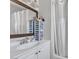 Bright bathroom featuring a sink with a mirrored cabinet and a shower with a white curtain at 4629 San Cir, Las Vegas, NV 89120