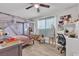 Bright bedroom with wood-look floors, a draped bed, and a workspace in the corner at 4629 San Cir, Las Vegas, NV 89120