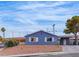 Charming single-story home showcasing a simplistic desert landscape and a driveway with covered parking at 4629 San Cir, Las Vegas, NV 89120