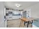 Well-lit kitchen with white cabinets, stainless steel appliances, and an adjacent table for dining at 4629 San Cir, Las Vegas, NV 89120