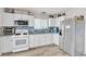 Updated kitchen with white cabinets, granite countertops, stainless steel appliances, and tile backsplash at 4629 San Cir, Las Vegas, NV 89120