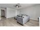 Open living room with a gray couch and ottoman set on wood floors and neutral wall color at 4629 San Cir, Las Vegas, NV 89120