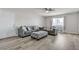 The staged living room features modern sofas, ottoman, and wood-look floors at 4629 San Cir, Las Vegas, NV 89120