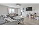 Spacious living room with modern furniture, a large window, and a wall-mounted TV at 4629 San Cir, Las Vegas, NV 89120