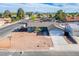 Elevated view of a single-story home with desert landscaping, a two-car garage, and mature trees at 4797 E Imperial Ave, Las Vegas, NV 89104