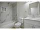 Bathroom featuring marble tile, a shower-tub combo, and a single-sink vanity at 4797 E Imperial Ave, Las Vegas, NV 89104