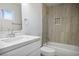 Modern bathroom with a shower-tub, marble countertops, and a tile backsplash at 4797 E Imperial Ave, Las Vegas, NV 89104