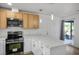 Bright kitchen featuring marble countertops, stainless steel appliances, and modern pendant lighting at 4797 E Imperial Ave, Las Vegas, NV 89104