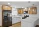 Modern kitchen with stainless steel appliances, white cabinets, granite countertops, and updated lighting at 4797 E Imperial Ave, Las Vegas, NV 89104