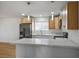 Open kitchen showcasing a marble-topped breakfast bar, stainless steel appliances, and recessed lighting at 4797 E Imperial Ave, Las Vegas, NV 89104