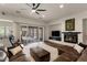 Comfortable living room with fireplace, tile floors, and sliding doors to the outdoor space at 48 Panorama Crest Ave, Las Vegas, NV 89135