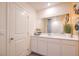 Modern bathroom featuring a vanity with white countertops, large mirror, and neutral tones at 4955 Sage Mesa Ave # Lot 150, Las Vegas, NV 89139