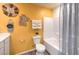 Colorful bathroom featuring a tub/shower combination, toilet, and vanity with unique decor at 4955 Sage Mesa Ave # Lot 150, Las Vegas, NV 89139