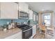 Well-equipped kitchen featuring quartz countertops, stainless steel appliances, and an adjacent dining area at 4955 Sage Mesa Ave # Lot 150, Las Vegas, NV 89139
