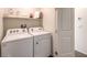 Efficient laundry room featuring a washer, dryer, and shelving for storage at 4955 Sage Mesa Ave # Lot 150, Las Vegas, NV 89139