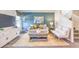 Cozy living room featuring a teal accent wall, modern furniture, and natural light from a large window at 4955 Sage Mesa Ave # Lot 150, Las Vegas, NV 89139