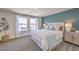 Comfortable main bedroom with white bedding, gray carpet, side tables, and soft natural lighting at 4955 Sage Mesa Ave # Lot 150, Las Vegas, NV 89139