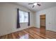 A bright bedroom featuring hardwood floors, natural light, and access to a walk-in closet at 4960 Harrison Dr # 214, Las Vegas, NV 89120