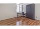 Bedroom featuring a murphy bed, desk and modern wood-look flooring at 4960 Harrison Dr # 214, Las Vegas, NV 89120