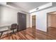 Bedroom featuring a murphy bed, desk and modern wood-look flooring at 4960 Harrison Dr # 214, Las Vegas, NV 89120