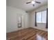 A bright bedroom featuring hardwood floors, natural light, and a view to the en-suite bathroom at 4960 Harrison Dr # 214, Las Vegas, NV 89120