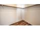Walk-in closet with wood-look flooring and white walls offers ample storage space at 4960 Harrison Dr # 214, Las Vegas, NV 89120