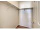 Walk-in closet with wood-look flooring and white walls offers ample storage space at 4960 Harrison Dr # 214, Las Vegas, NV 89120