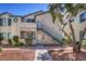 Multi-Gathering house exterior with tidy landscaping, staircases and private entrances at 4960 Harrison Dr # 214, Las Vegas, NV 89120