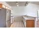 Bright kitchen with stainless steel appliances, white cabinets and track lighting at 4960 Harrison Dr # 214, Las Vegas, NV 89120