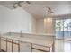 Open kitchen space with white countertops, bright lighting, and a view to the outdoor patio at 4960 Harrison Dr # 214, Las Vegas, NV 89120