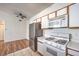 Kitchen with stainless steel refrigerator, white cabinets, gas range and tile floors at 4960 Harrison Dr # 214, Las Vegas, NV 89120