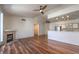Bright living room with fireplace, ceiling fan and wood floors open to kitchen with stainless steel appliances at 4960 Harrison Dr # 214, Las Vegas, NV 89120