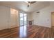 Bright living room with sliding glass door, fireplace and wood floors at 4960 Harrison Dr # 214, Las Vegas, NV 89120